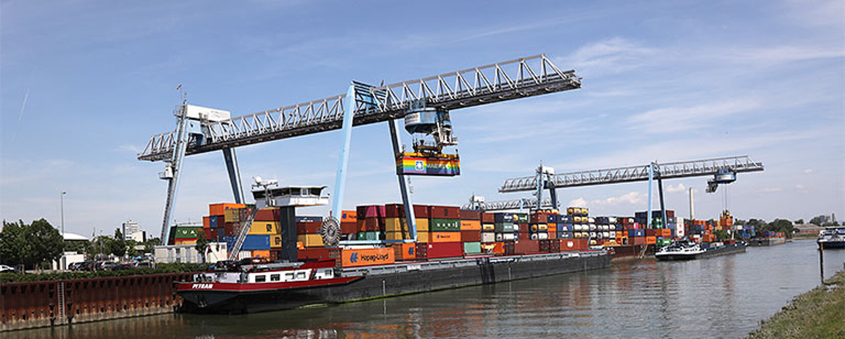 Krananlage entlädt ein Binnenschiff am Container-Terminal Ludwigshafen
